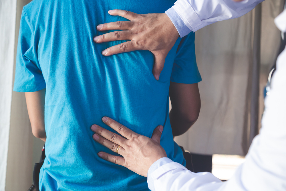 Doctor consulting a patient with Back problems.